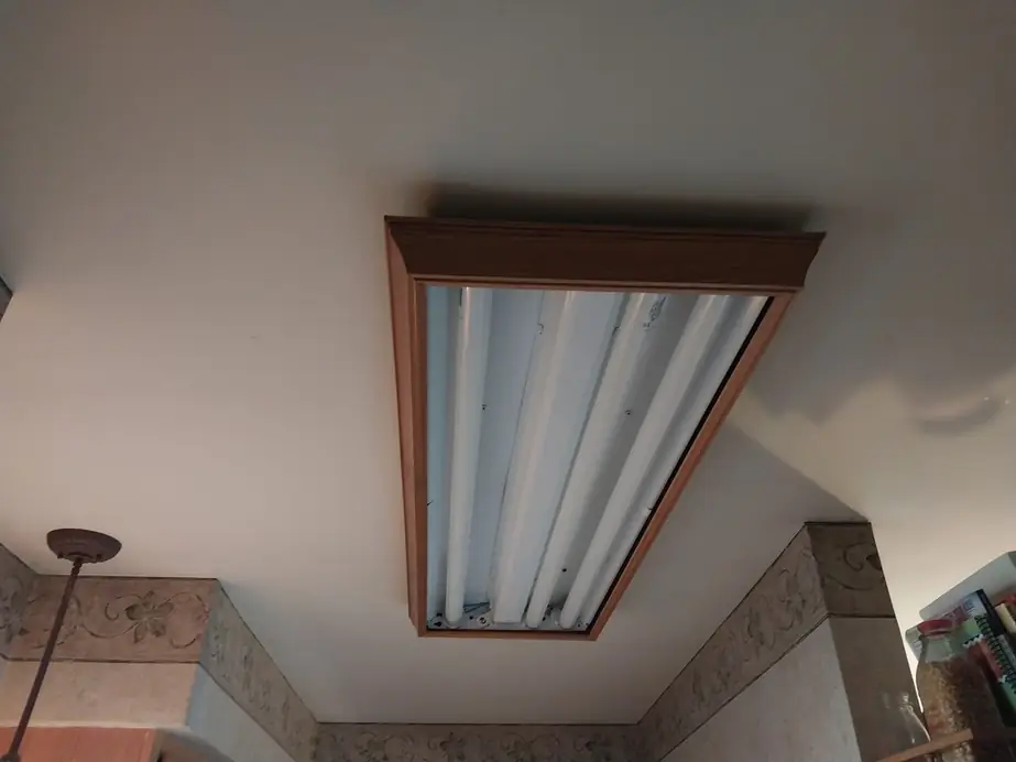 Ceiling-mounted fluorescent light fixture in a finished room
