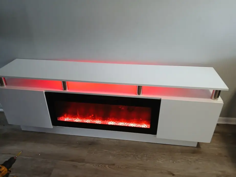 Finished white TV console with the electric fireplace lit and a red LED glow under the top shelf